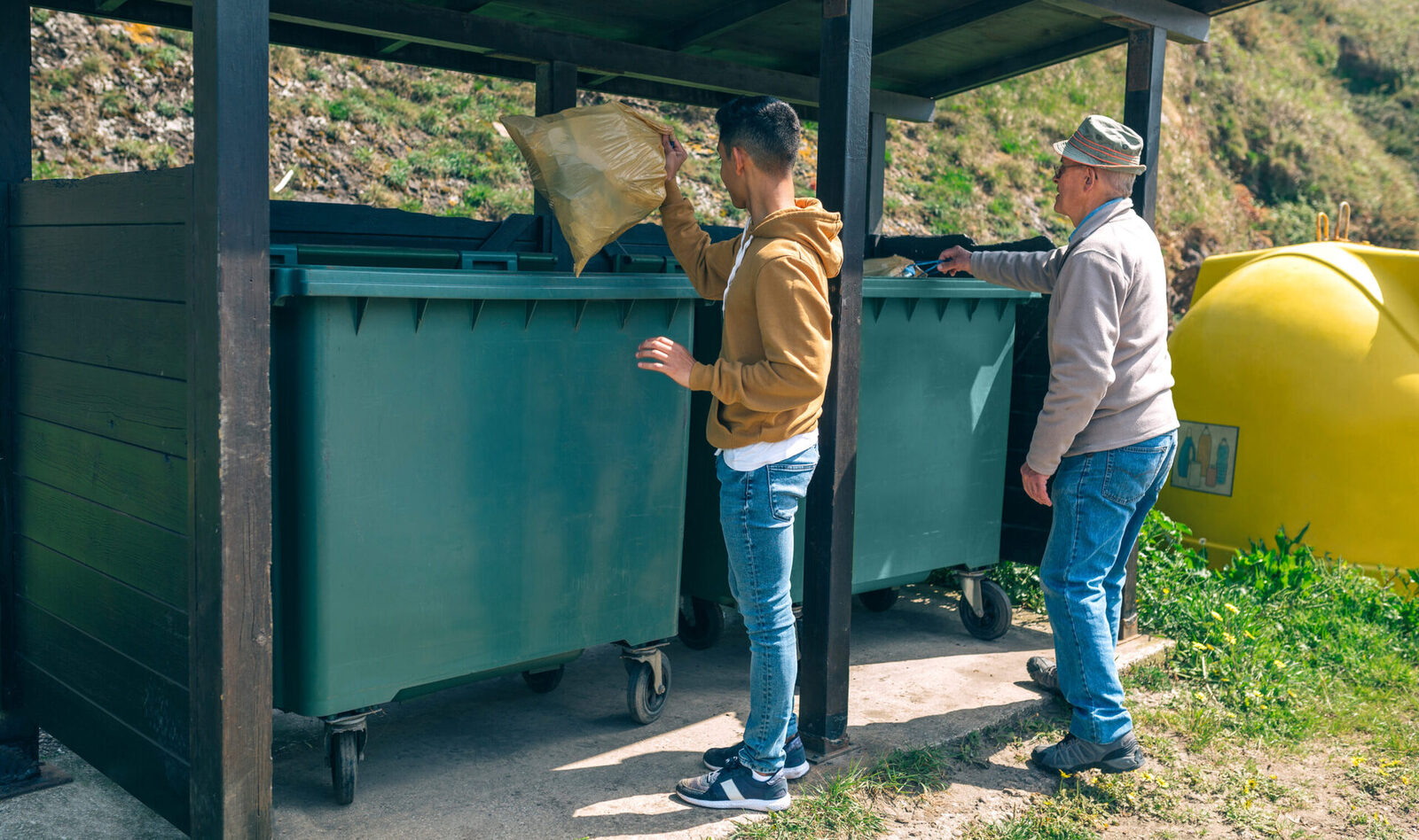 men throwing garbage to container 2023 11 27 04 49 13 utc scaled 1