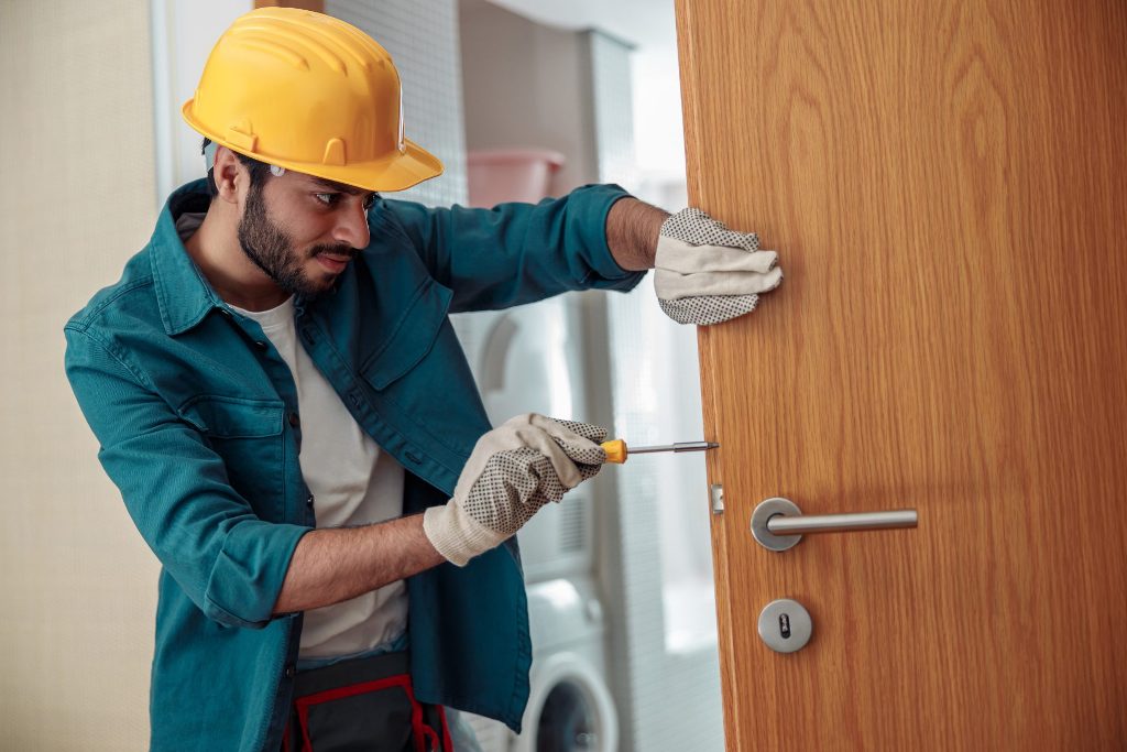 24-Hour Locksmith Matthews – Residential & Auto Help 1 locksmith workman in uniform installing door knob 2023 01 05 00 20 11 utc